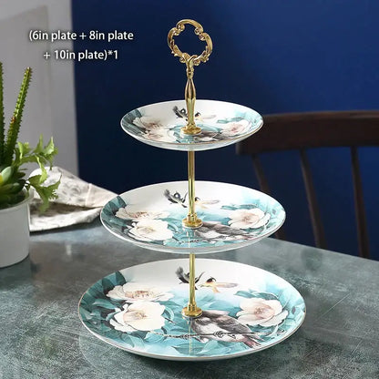 Three-tiered bone china fruit plates set with floral and bird motifs and gold-toned ornate handle for dining room use