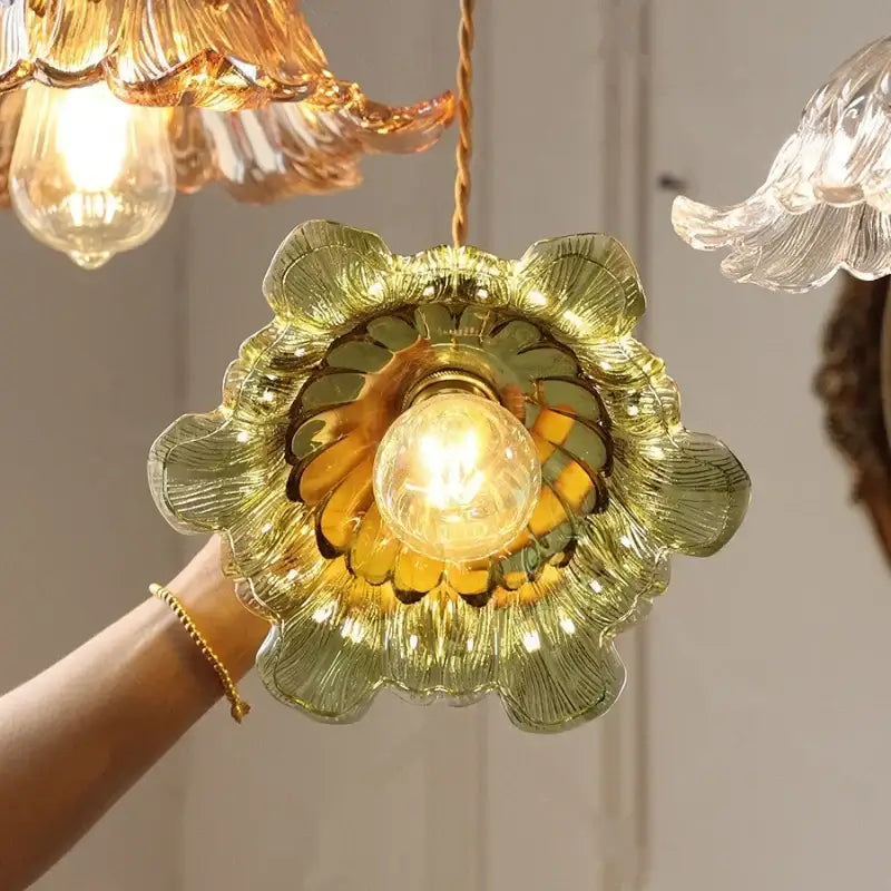 Floral green and champagne glass pendant light with petal design and exposed bulb for dining room lighting