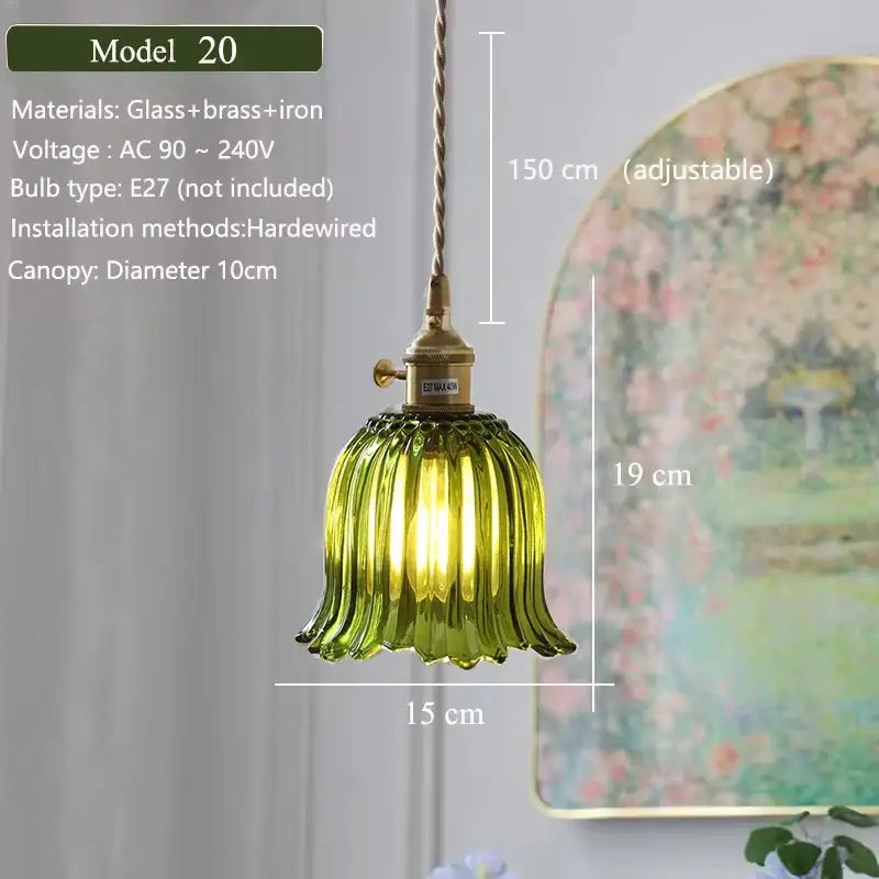 Floral green glass pendant light with brass and iron hardware featuring a green glass shade for kitchen use