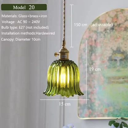 Floral green glass pendant light with brass and iron hardware featuring a green glass shade for kitchen use