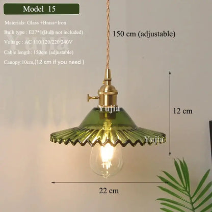 Floral green glass and brass pendant light with visible bulb and green glass shade for kitchen use