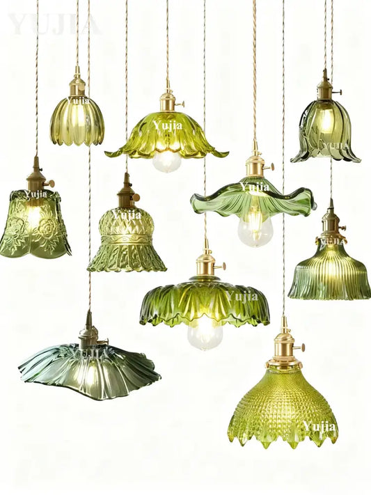 A collection of elegant pendant lights with green glass shades and brass fixtures featuring floral and ruffled designs