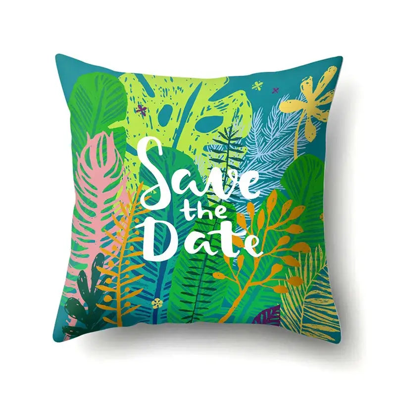 Vibrant pillow cover with green tropical leaves and save the date script on plush fabric for decorbites green tropical decor
