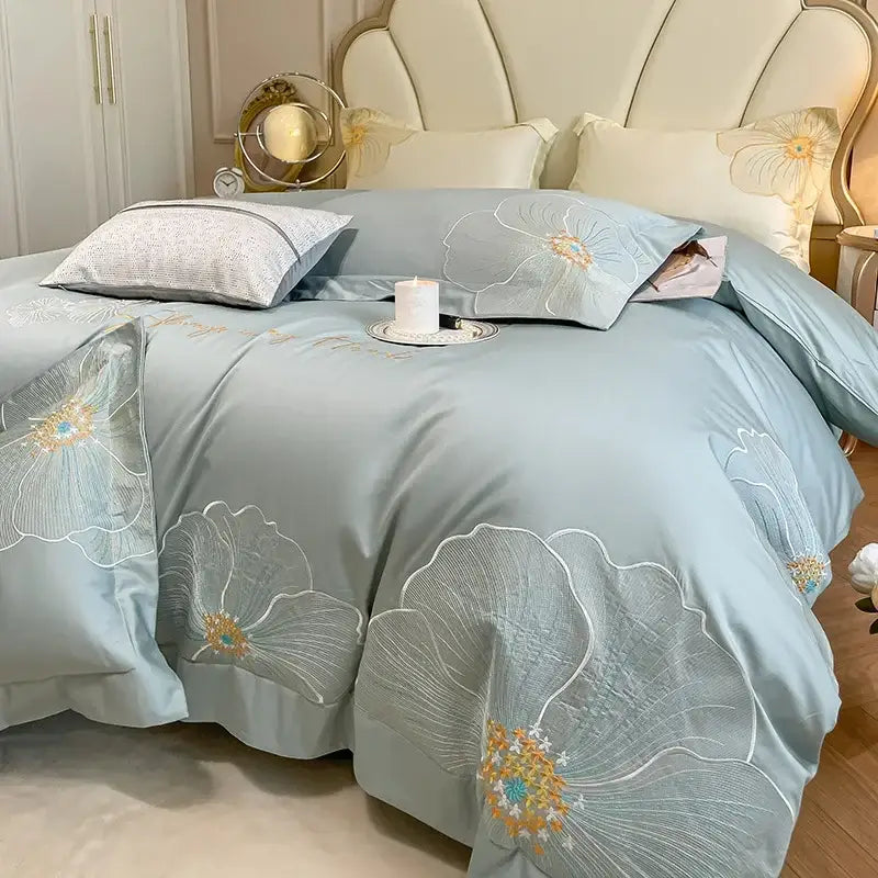 Light blue satin duvet cover set with delicate white gold and teal floral embroidery in egyptian cotton bedding set