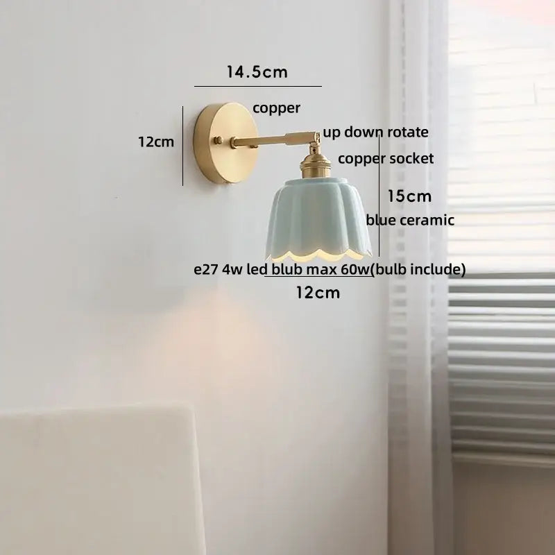 Delicate blue ceramic wall light fixture with fluted petal design and copper mounting hardware for bedroom use