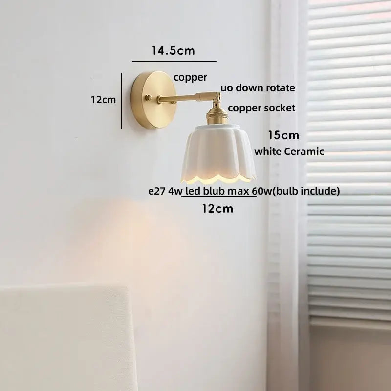 White ceramic lampshade with scalloped edge on copper wall light fixture for bedroom with gold pull chain