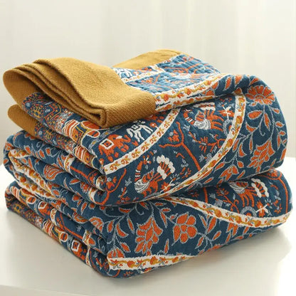 Stacked quilted pants in navy blue with vibrant orange white floral patterns and mustard yellow cuff for decorbites cotton picnic blanket bedspread