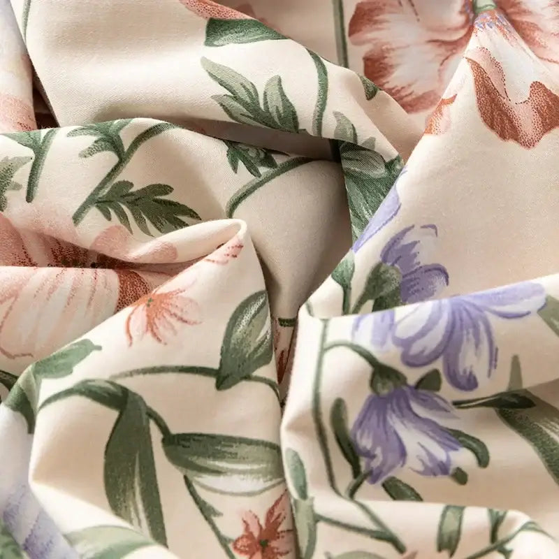 Soft cream-colored bedding set with delicate pink purple floral pattern made of decorbites 100s egyptian cotton