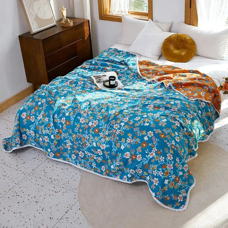 Vibrant turquoise floral sofa cover with white lace trim and orange pink cream blossoms made of decorbites breathable cotton gauze