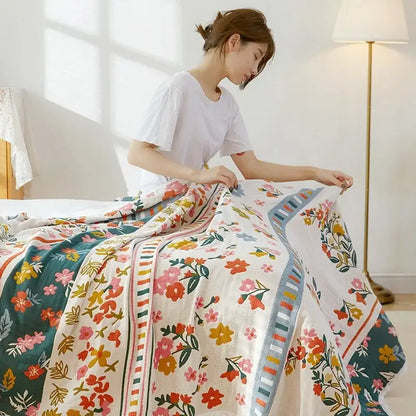 A woman holds a vibrant floral patchwork breathable cotton gauze sofa cover for living room decor