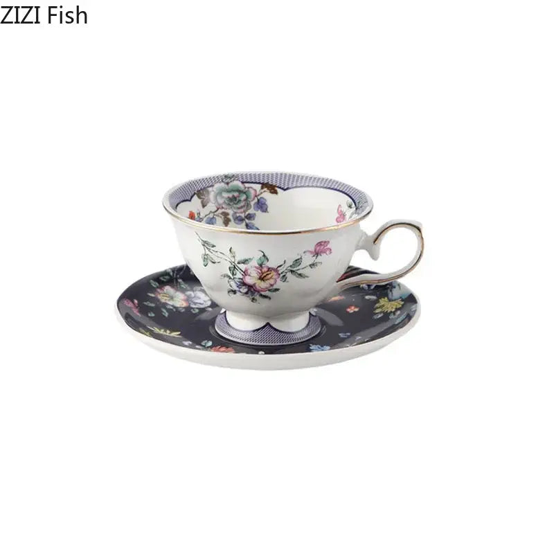 A ceramic cup and saucer set with delicate decorbites flowers pattern in pastel hues and gold-trimmed edges on dark background