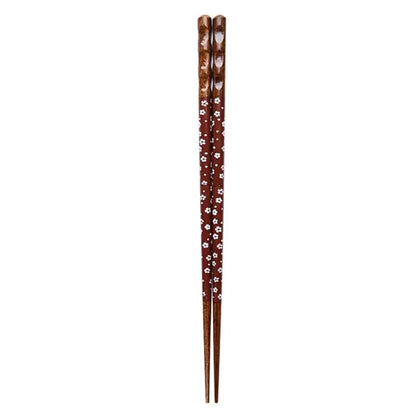 A pair of brown bamboo wood chopsticks with a delicate white floral pattern for an enhanced dining experience
