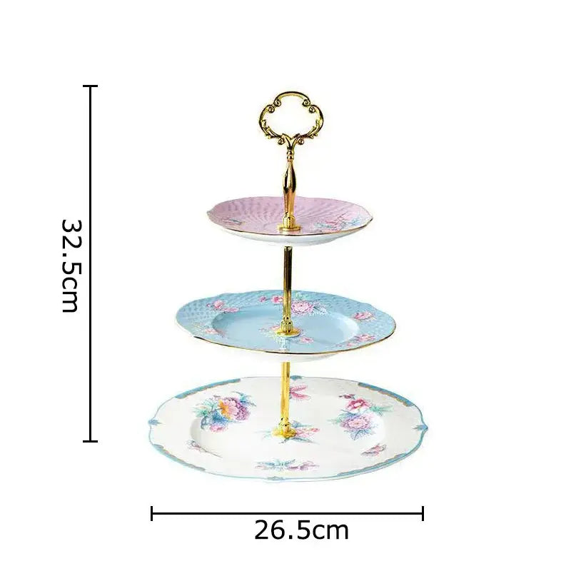 Three-tiered porcelain dessert stand with floral patterns and gold-toned handle complementing the floral pink and purple coffee mug set