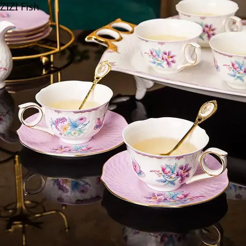 Floral pink and purple porcelain coffee mug set with gold trim featuring teacups, saucers, and golden spoons