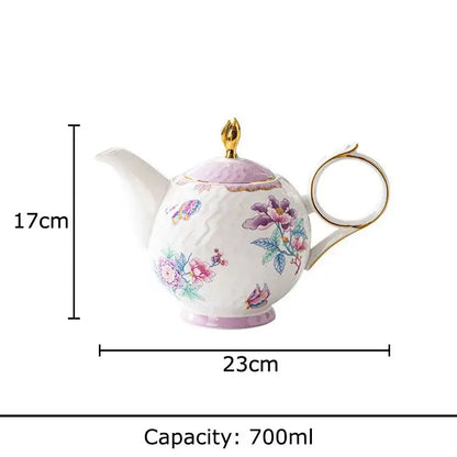 A delicate white porcelain coffee mug set with floral and butterfly patterns in pastel hues and gold trim
