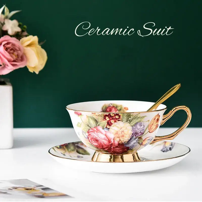 Delicate white ceramic tea cup set with vibrant pink and purple floral pattern and gold trim perfect for dining room use