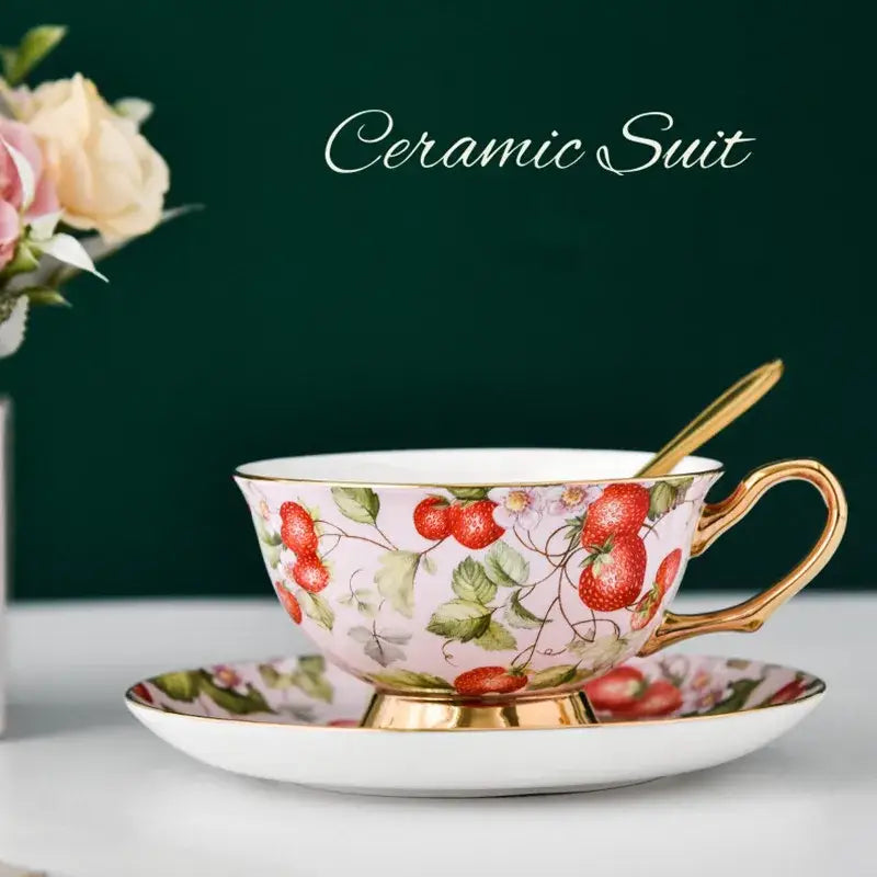 Floral pink and purple porcelain tea cup set with gold trim and strawberry pattern perfect for dining room or coffeeware use