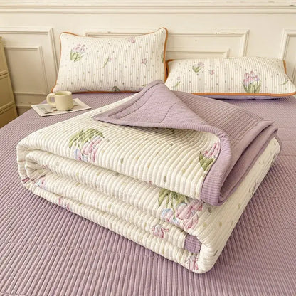 A soft lavender and cream floral quilt with ribbed texture and folded edges in decorbites cartoon small fresh bed sheets