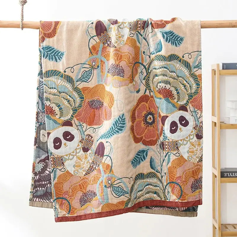 Beige soft bath towel with vibrant floral and panda pattern in orange teal and brown made of decorbites cotton gauze