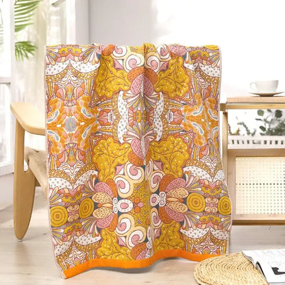 A vibrant floral pink and yellow cotton gauze bath towel with psychedelic pattern for bathroom decorbites cotton gauze decor