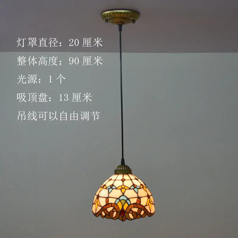 A warm-toned floral stained glass pendant light in amber yellow and teal hues decorbites baroque tiffany design