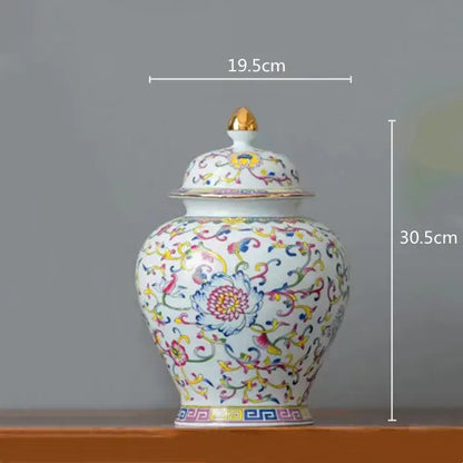 A white enamelled porcelain tea caddy ginger jar with multicolored floral patterns and a gold-tipped lid for dining room use