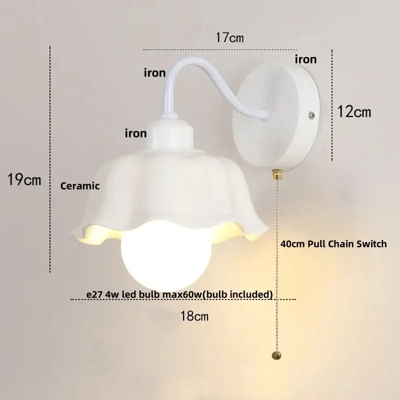Floral white glass iron led wall sconce with pull chain featuring a white ceramic petal shade and iron bracket decorbites glass iron