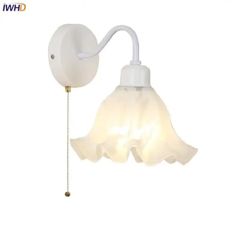 White wall sconce with frosted floral glass shade and iron curved arm featuring a pull chain switch by decorbites glass iron led