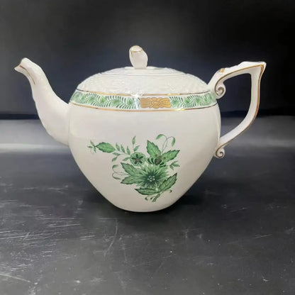 White porcelain teapot with green floral and leaf patterns and gold trim from floral white and green ceramic tea cup set
