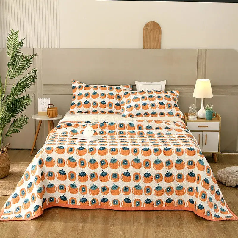 Orange pumpkin patterned quilt with blue accents on white background in floral white and green cotton double bedspread decorbites set