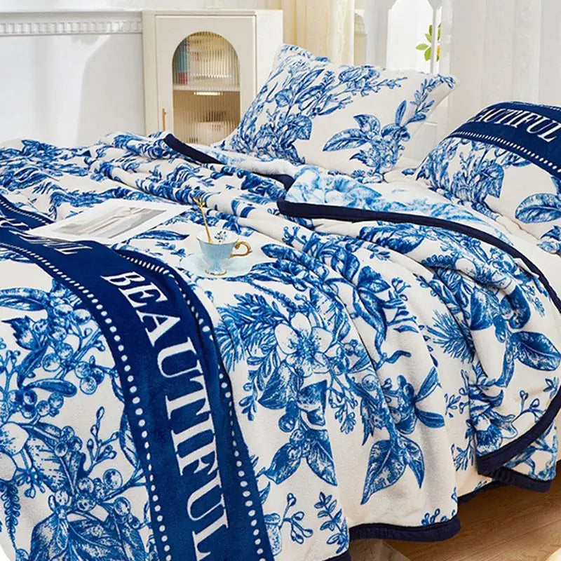 Floral white and navy cozy flannel plush blanket with blue and white floral pattern and beautiful text edge decorbites cozy flannel
