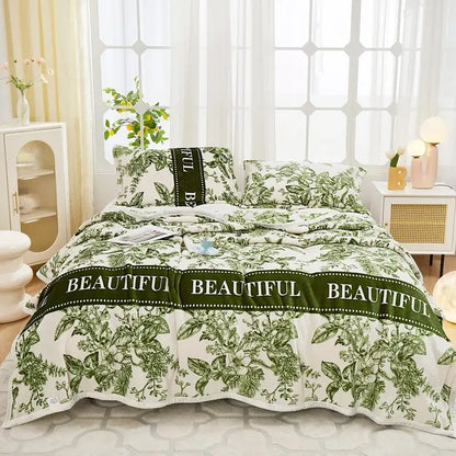 Floral white and navy cozy flannel plush blanket featuring green and white botanical print bed set with beautiful banner