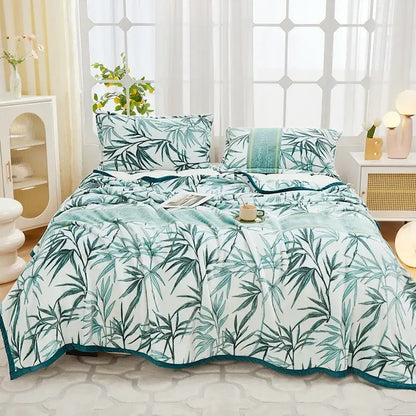 A floral white and navy cozy flannel plush blanket with a soft white duvet cover featuring green bamboo leaves and teal trim