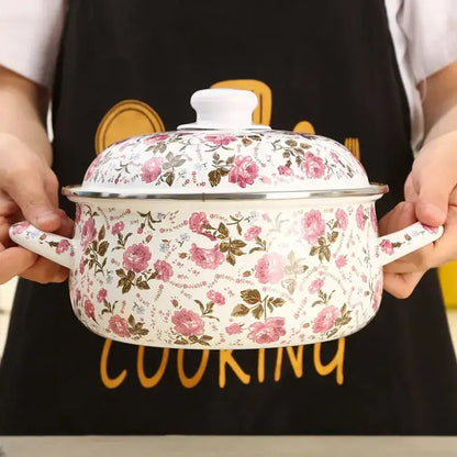 A white enamel ceramics soup saucepan with pink and brown floral patterns and matching lid in silver rim
