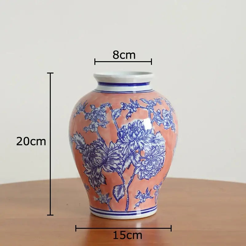 Peach-colored porcelain vase with intricate blue floral patterns and white rim for living room decor