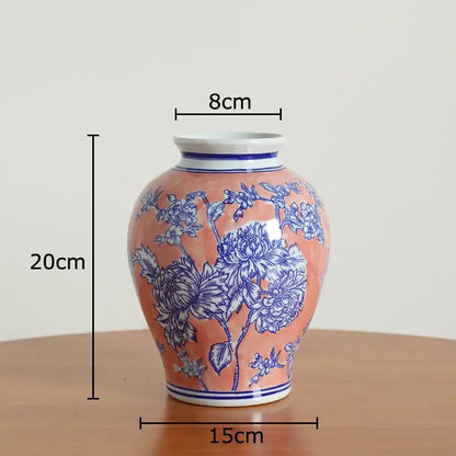 Peach-colored porcelain vase with intricate blue floral patterns and white rim for living room decor