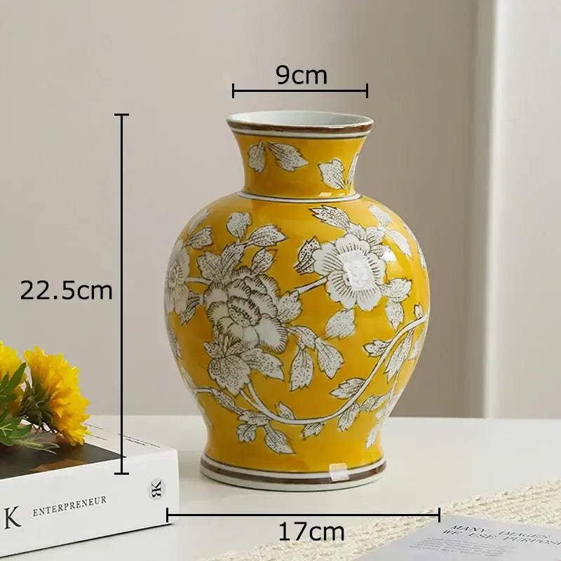 A vibrant yellow porcelain vase with white floral patterns and brown trim for living room decor