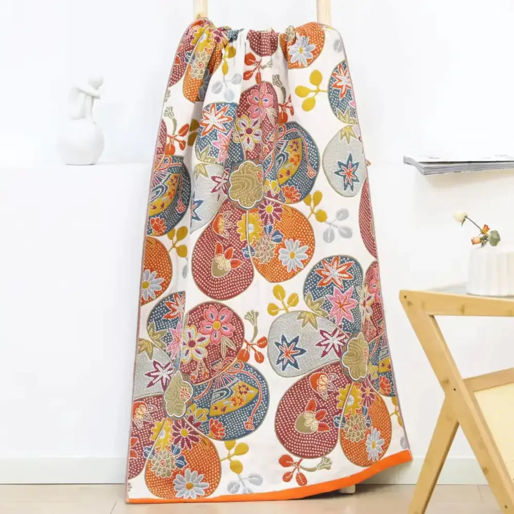 Vibrant cotton gauze floral bath towel with white base and multicolor floral motifs for quick dry bathroom use