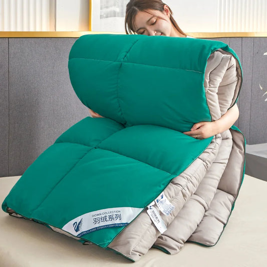 Teal and beige quilted down comforter with swan logo label featuring quilt code for lightweight warm winter use