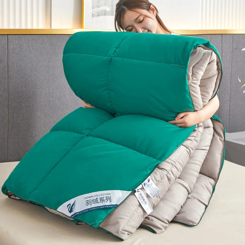 Teal and beige quilted down comforter with swan logo label featuring quilt code for lightweight warm winter use