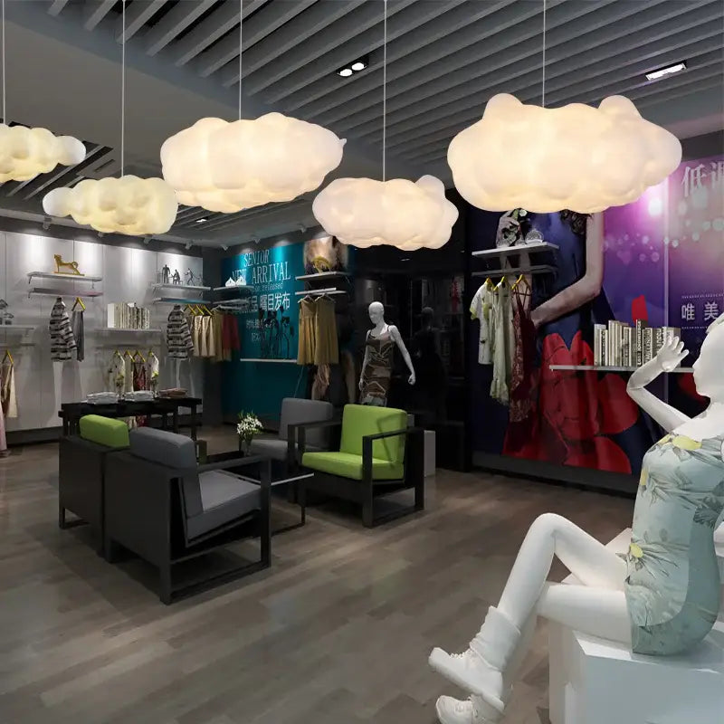 Fluffy white cloud ceiling chandelier with opaque white material pendant lights emitting soft warm glow