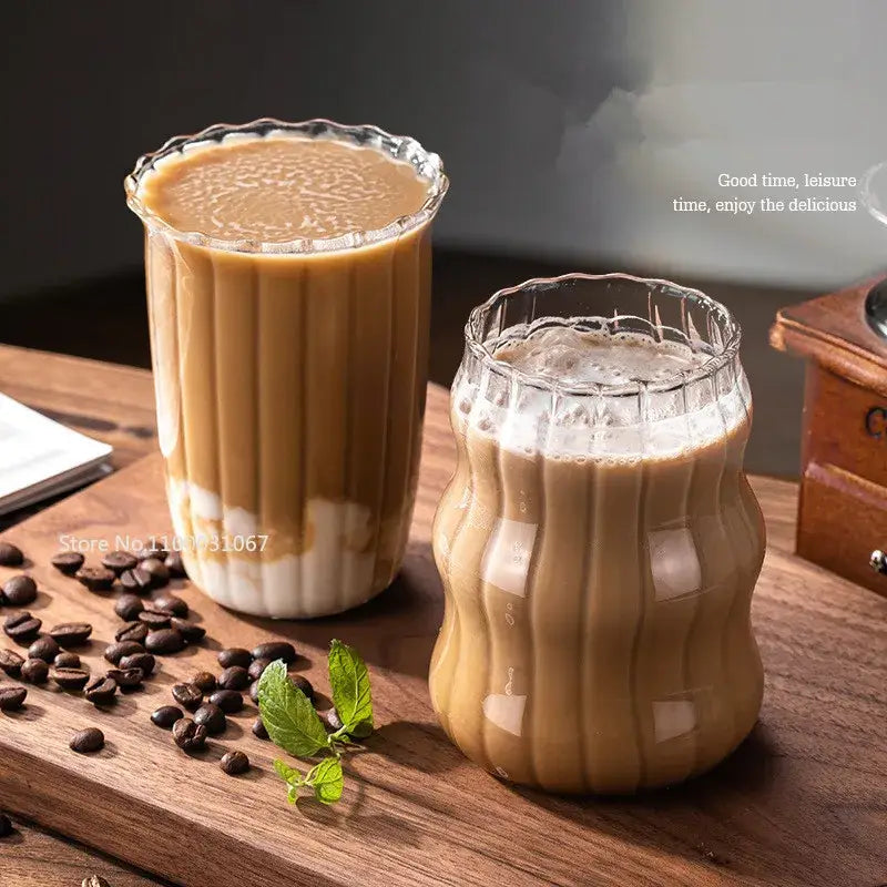 Two clear fluted glass coffee mugs with vertical ridges and scalloped rims in a decorbites coffee mug set