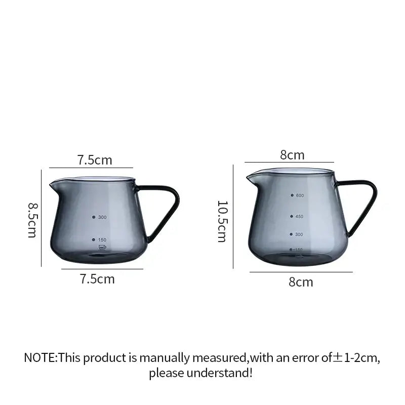Two sleek dark gray glass coffee pots with black handles and precise volume markings in a fluted clear glass design
