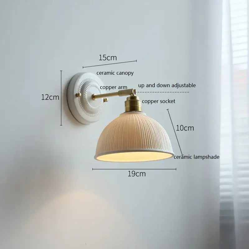Fluted cream ceramic wall lamp with ribbed texture mounted on brass copper arm for bathroom decorbites ceramic wall lighting