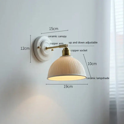 Fluted cream ceramic wall lamp with ribbed texture mounted on brass copper arm for bathroom decorbites ceramic wall lighting