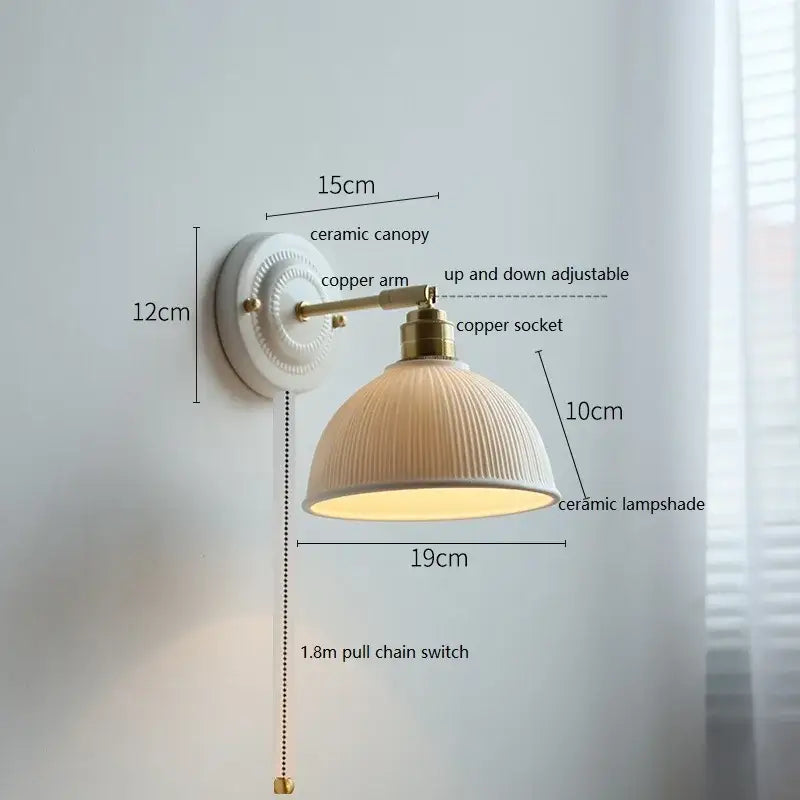Fluted cream ceramic wall lamp with vertical ridges mounted on brass copper arm for decorbites ceramic wall lighting