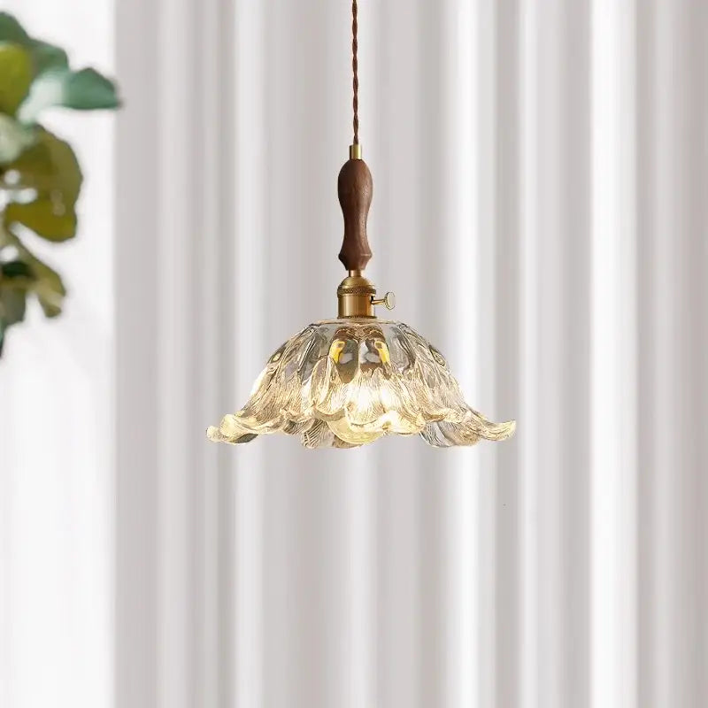 A delicate translucent fluted glass led pendant lamp with brass accents for elegant dining room lighting