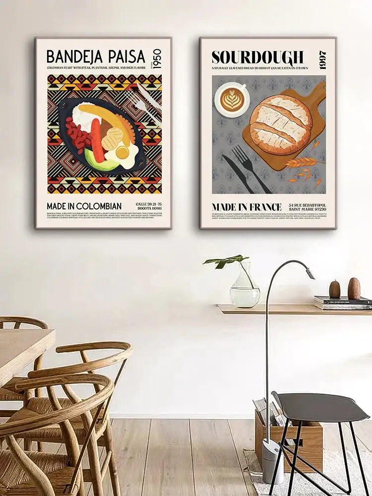 Two framed vintage-style canvas paintings featuring colorful colombian bandeja paisa and rustic sourdough loaf wall art