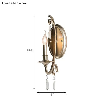 Antique brass finish sconce light with curved ornate design and crystal teardrop pendants for bedroom wall lamp