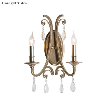 Antique brass two-light sconce light with crystal teardrop pendants in french country brass finish wall lamp design